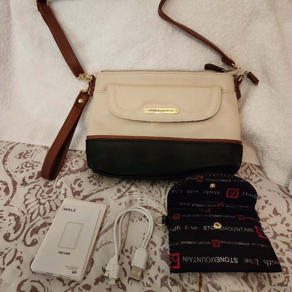 Stylish cream and black leather crossbody bag with mobile charging battery